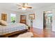 Bright bedroom featuring hardwood floors, ceiling fan, and decor at 3919 Evans Rd, Cumming, GA 30040