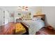 Cozy bedroom with hardwood floors, ceiling fan, and cushioned bench at 3919 Evans Rd, Cumming, GA 30040