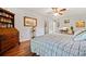 Bedroom featuring hardwood floors, desk area, and a comfortable bed at 3919 Evans Rd, Cumming, GA 30040
