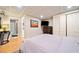 Bedroom featuring wood-look floors, TV, double door closet, and an adjacent bathroom at 3919 Evans Rd, Cumming, GA 30040