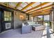 Inviting covered porch with a fire pit, comfortable seating, and wood ceiling at 3919 Evans Rd, Cumming, GA 30040