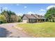 Charming single-Gathering home with a dark gray exterior and attached garage on a sprawling green lawn at 3919 Evans Rd, Cumming, GA 30040