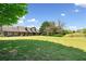 Beautiful single-Gathering home with a sprawling green lawn under a sunny sky at 3919 Evans Rd, Cumming, GA 30040