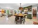 Eat-in kitchen features green cabinetry, stainless steel appliances, and stylish light fixture at 3919 Evans Rd, Cumming, GA 30040