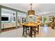 Open kitchen boasts an island table with seating, stylish light fixture and views to the living room at 3919 Evans Rd, Cumming, GA 30040