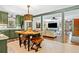 Eat-in kitchen flows into the living room and has green cabinetry and stainless steel appliances at 3919 Evans Rd, Cumming, GA 30040