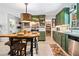 Cozy kitchen with green cabinets, stainless appliances, and an island table with barstool seating at 3919 Evans Rd, Cumming, GA 30040