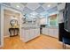 Bright kitchenette with white cabinets, granite countertops, stainless steel appliances, and wood-look floors at 3919 Evans Rd, Cumming, GA 30040