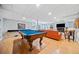 Finished basement with a pool table, and an orange leather sofa by the fireplace at 3919 Evans Rd, Cumming, GA 30040