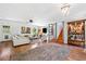 Open-concept living room with hardwood floors, white sofa, and decorative shelving at 3919 Evans Rd, Cumming, GA 30040