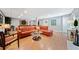 Open living room with wood-look floors, comfortable seating, a pool table, and ample lighting at 3919 Evans Rd, Cumming, GA 30040