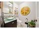Charming powder room with a decorative sink and unique wall art at 3919 Evans Rd, Cumming, GA 30040