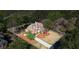 Aerial view of a brick home with a well-manicured lawn and long driveway at 6690 Stillmeadow Dr, Cumming, GA 30040