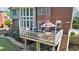 Lovely back porch with outdoor furniture, grill, and serene view of the backyard at 6690 Stillmeadow Dr, Cumming, GA 30040