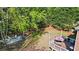 Serene backyard featuring a fire pit, deck with umbrella-covered table, and lush greenery at 6690 Stillmeadow Dr, Cumming, GA 30040
