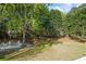 Lush backyard with a fire pit and Adirondack chairs, perfect for outdoor entertaining at 6690 Stillmeadow Dr, Cumming, GA 30040