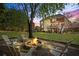 Cozy backyard with a stone fire pit area, perfect for evenings outdoors with friends at 6690 Stillmeadow Dr, Cumming, GA 30040