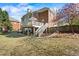 Beautiful backyard with a deck, outdoor seating, and lush landscaping, perfect for relaxation at 6690 Stillmeadow Dr, Cumming, GA 30040