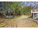 Large grassy backyard with adirondack chairs and a firepit, perfect for outdoor enjoyment at 6690 Stillmeadow Dr, Cumming, GA 30040