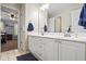 Bright bathroom with a double vanity and a tiled floor, leading to the bedroom at 6690 Stillmeadow Dr, Cumming, GA 30040