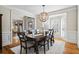 Dining room featuring a wood table, chair set and modern lighting fixture at 6690 Stillmeadow Dr, Cumming, GA 30040