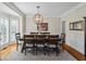 Dining room with a modern chandelier, a large dining table, and natural light from the windows at 6690 Stillmeadow Dr, Cumming, GA 30040