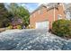 Home features a spacious driveway, basketball hoop and well-manicured landscaping at 6690 Stillmeadow Dr, Cumming, GA 30040