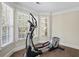 This exercise room has an elliptical, natural light and views of the outdoors at 6690 Stillmeadow Dr, Cumming, GA 30040