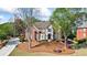 Charming two-story home with brick and siding exterior, mature trees, and well-maintained front yard at 6690 Stillmeadow Dr, Cumming, GA 30040