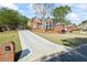 Stunning brick home features beautiful landscaping, mature trees and a long driveway at 6690 Stillmeadow Dr, Cumming, GA 30040
