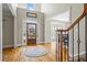 Bright foyer with hardwood floors, a decorative rug, and staircase with iron spindles at 6690 Stillmeadow Dr, Cumming, GA 30040