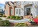 Inviting front entrance with beautiful landscaping, brick walkway, and a charming front door at 6690 Stillmeadow Dr, Cumming, GA 30040