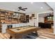 This game room includes a pool table, a bar, shelving, and seating at 6690 Stillmeadow Dr, Cumming, GA 30040