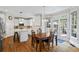 Eat-in kitchen with stainless steel appliances, island, and breakfast nook with backyard access at 6690 Stillmeadow Dr, Cumming, GA 30040