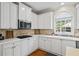 Kitchen with ample white cabinets, stainless appliances, granite countertops, and tile backsplash at 6690 Stillmeadow Dr, Cumming, GA 30040