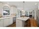 Sunlit kitchen with stainless steel appliances and an island with seating at 6690 Stillmeadow Dr, Cumming, GA 30040