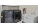 Functional laundry room with a washer and dryer plus a utility sink at 6690 Stillmeadow Dr, Cumming, GA 30040