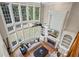 Living room featuring two-story windows, fireplace, built-in shelving, and a ceiling fan at 6690 Stillmeadow Dr, Cumming, GA 30040