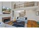 Living room with a fireplace, built-in shelving, and a view of the second-floor balcony at 6690 Stillmeadow Dr, Cumming, GA 30040