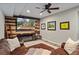Basement living room with modern wood paneling, fireplace and a large sectional at 6690 Stillmeadow Dr, Cumming, GA 30040
