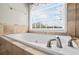 Close-up of the soaking tub with tile surround in the main bathroom at 6690 Stillmeadow Dr, Cumming, GA 30040