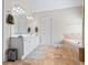 The main bathroom has a white double vanity, a soaking tub, and tile floors at 6690 Stillmeadow Dr, Cumming, GA 30040
