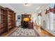 Elegant office space with hardwood floors, built-in bookshelves, and a large desk at 6690 Stillmeadow Dr, Cumming, GA 30040