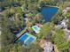 Aerial view showcasing tennis courts, a swimming pool, and lush landscaping at 255 Sageglen Rd, Lawrenceville, GA 30044
