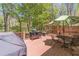 Spacious back deck with grill, outdoor seating, and views of the surrounding trees, ideal for relaxation at 255 Sageglen Rd, Lawrenceville, GA 30044