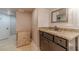 Bathroom featuring vanity with granite top, storage cabinet, mirror, and light fixtures creating a cozy atmosphere at 255 Sageglen Rd, Lawrenceville, GA 30044