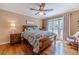 Comfortable bedroom with hardwood floors, a large window, and neutral paint, creating a relaxing retreat at 255 Sageglen Rd, Lawrenceville, GA 30044