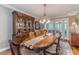 Dining room with a large wooden table, china cabinet, and access to outdoor space at 255 Sageglen Rd, Lawrenceville, GA 30044