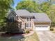 Charming home featuring a stone facade, well-manicured lawn, and attached two-car garage at 255 Sageglen Rd, Lawrenceville, GA 30044