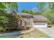Charming stone and stucco home featuring an attached two-car garage and well-manicured front lawn and professional landscaping at 255 Sageglen Rd, Lawrenceville, GA 30044